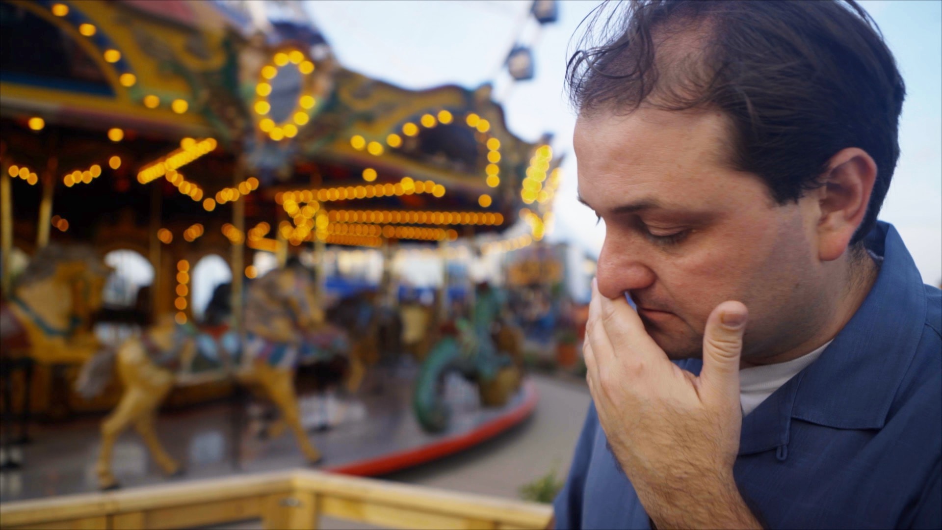 Man at carnival reflecting