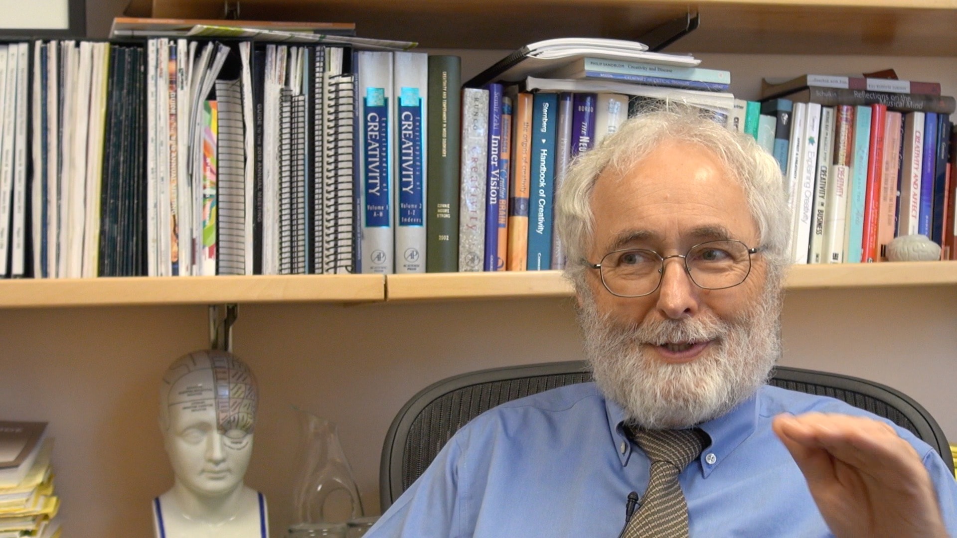 Professor in front of bookshelf
