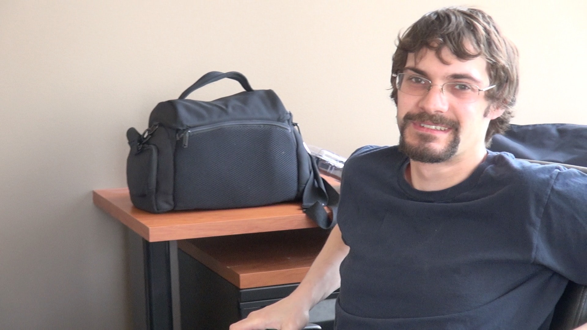 BTS man with camera bag
